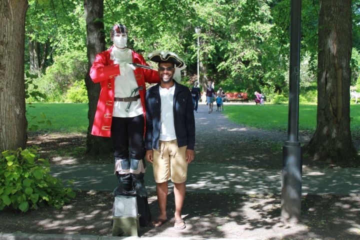 Gave him money and he put the hat on David and pulled out the gun after he stood next to him.